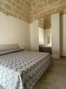 a bedroom with a large bed and a mirror at Donna Maria Pina in Monopoli