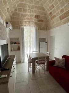 a kitchen and dining room with a table and a couch at Donna Maria Pina in Monopoli +22 photos