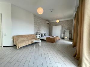 a bedroom with a bed and a couch and a table at Meidan View in Tbilisi City