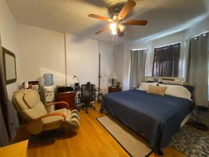 a bedroom with a bed and a ceiling fan at Room with Jacuzzi, Massage Seat, and Parking Spac, THE BEST CHOICES!! in North Bergen
