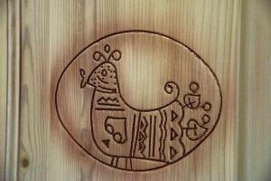 a drawing of a horse on a wooden wall at Hotel L'Oleandro in Villasimius