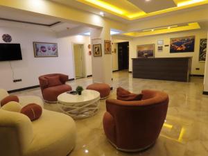 a lobby with couches and chairs and a television at Kadeer Hotel in Alanya