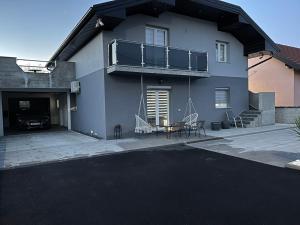 a house with a balcony and a table and chairs at Una Bihac 4 in Bihać