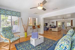 a living room with a couch and chairs and a ceiling fan at Sapphire Shores - Sarasota Bungalow w/ Heated Pool and Backyard Oasis in Sarasota