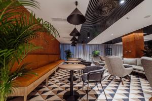 a lobby with a couch and chairs and tables at Elements Hotel&Spa in Świeradów-Zdrój