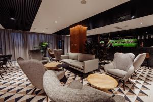 a lobby with chairs and tables and a bar at Elements Hotel&Spa in Świeradów-Zdrój