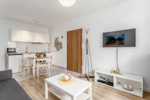 a living room with a couch and a table at Chill Apartments Praga Południe in Warsaw