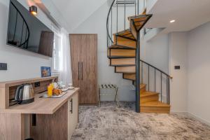 a kitchen with a spiral staircase in a house at Makarun Heritage Rooms in Split