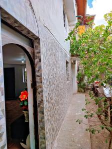 an entrance to a building with a stone wall at ENEDE HOSTEL in Cusco