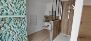 a small bathroom with a shower and a staircase at CHAMBRES D'HOTES MANDACHAINA in Camou-Mixe-Suhast