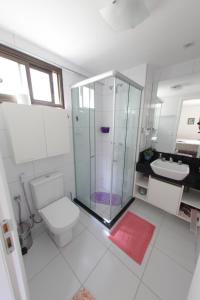 a bathroom with a shower and a toilet and a sink at Manhattan Riviera Beach in Aquiraz