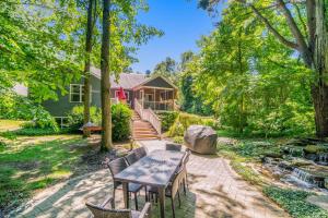 a backyard with a table and chairs and a house at Borrowed Thyme in Saugatuck