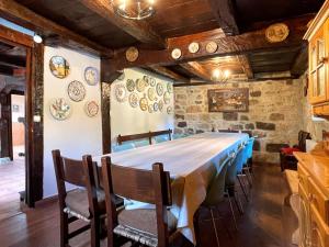 a dining room with a long table and chairs at Casa Rural Puerto del Escudo in Cilleruelo de Bezana