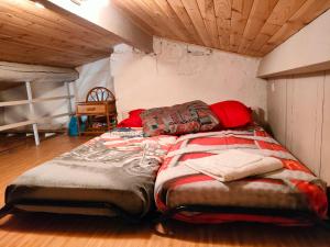1 Schlafzimmer mit 2 Betten in einem Zimmer mit Holzdecke in der Unterkunft Le Studio 2 in Uzès