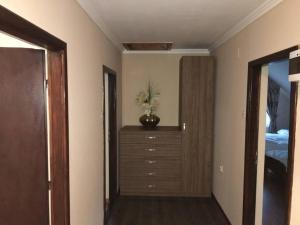 a bedroom with a dresser with a vase of flowers on it at Aleu - Apuseni Mountains in Pietroasa +28 photos