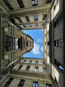 a view from the bottom of a tall building at A5 Apartment - Budapest - hostAID in Budapest