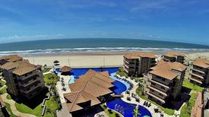 an aerial view of a resort with a beach and buildings at Manhattan Riviera Beach in Aquiraz