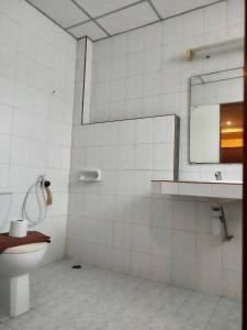 a bathroom with a toilet and a mirror at Ban Elephant Blanc Apartment in Kata Beach +30 photos