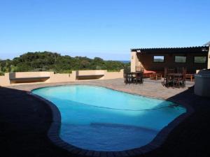 a large blue swimming pool next to a house at THE HAVEN HOTEL in Mpume