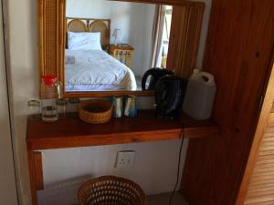 a bedroom with a bed and a mirror on a shelf at THE HAVEN HOTEL in Mpume