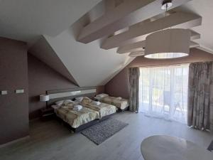 a bedroom with two beds and a large window at Apartament Tignes Czarna Góra in Sienna