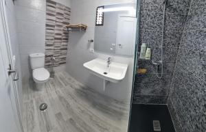 a bathroom with a toilet and a sink and a shower at SUMMERLAND SUNSET in Los Cristianos