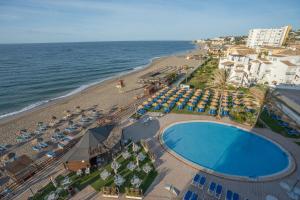 an aerial view of a beach with a swimming pool and the ocean at VIK Gran Hotel Costa del Sol in La Cala de Mijas