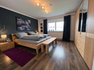 a bedroom with a bed and a table in it at Urlaub am Sonnenhügl in Rinchnach