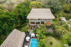an aerial view of a house with a thatched roof at Casa Origen in Los Naranjos