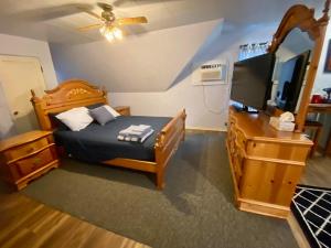 a bedroom with a bed and a flat screen tv at Diamond Apartment with GYM - 2 miles to Fort Sill & just blocks to downtown! in Lawton