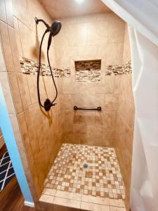 a bathroom with a shower with a checkered floor at Diamond Apartment with GYM - 2 miles to Fort Sill & just blocks to downtown! in Lawton +14 photos