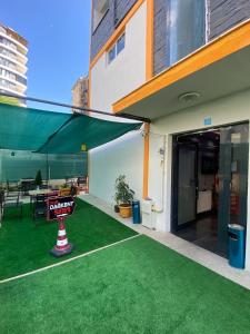 a building with a sign on the grass in front of it at dagkent plus suit in Tokat