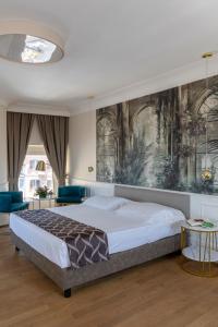 a bedroom with a large bed and a painting on the wall at Hotel Scalinata Di Spagna in Rome +278 photos