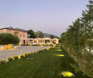 a person walking down a lawn in front of a house at Ca' del Conte - Maison de Charme in Padula