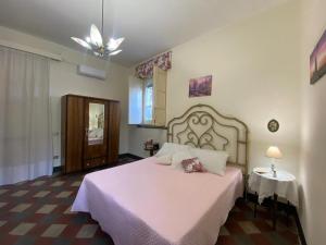 a bedroom with a large bed with a white blanket at Etna Maison in Zafferana Etnea