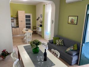 a living room with a couch and a table at Etna Maison in Zafferana Etnea
