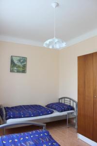 a room with a bunk bed and a cabinet and a bed at Domek u lesa in Bítov