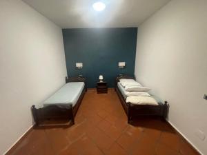 Zimmer mit 3 Betten und blauer Wand in der Unterkunft Sant'onofrio suite 2.0 in Trabia