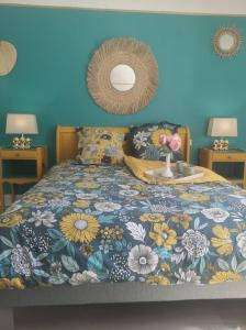 Schlafzimmer mit einem Bett mit blauer Wand in der Unterkunft L'EssenCiel du Lac in Éguzon-Chantôme
