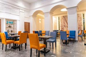 a dining room with tables and chairs at Hotel Majestic in Casablanca