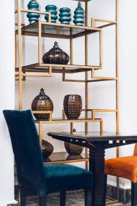 a dining room with a table and chairs and shelves with vases at Hotel Majestic in Casablanca