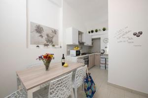a kitchen with a table with flowers on it at Amalfi 90 - holiday house close the beach in Atrani