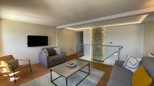 a living room with a couch and a table at SeaHouse Apartments in Piran