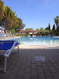 a blue bench in front of a swimming pool at Mobile home Comfort Viareggio - Camping Paradiso- R028 in Viareggio