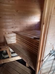 a wooden sauna with a ladder in it at Aatami in Kangasniemi