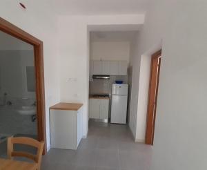 a kitchen with a white refrigerator and a sink at La Marina Bay in Vieste