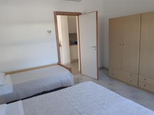 a bedroom with two beds and a mirror at La Marina Bay in Vieste