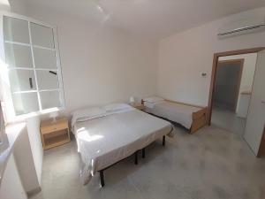 a bedroom with two beds and a window at La Marina Bay in Vieste