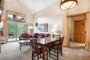 a dining room with a table and chairs and a couch at Copper Springs in Copper Mountain