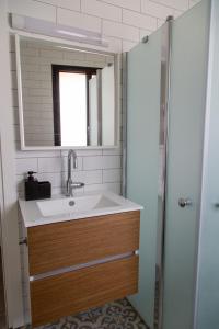 a bathroom with a sink and a mirror at The Alexander Apartment in Tel Aviv